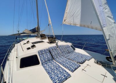 sailing catamaran foredeck with blue cushions
